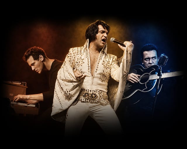 Tribute artists on stage in red, amber and blue light: Jerry Lee Lewis at the piano, Elvis Presley at the microphone and Johnny Cash with an acoustic guitar.